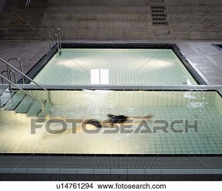 Woman swimming under water in swimming pool View Large Photo Image Picture - Woman swimming under water in swimming pool. Fotosearch