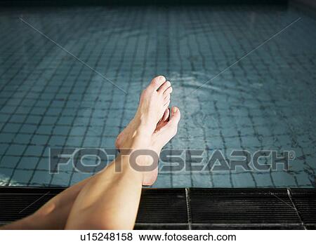 Woman with feet in swimming pool, low section View Large Photo Image Stock Photo - Woman with feet in swimming pool, low section. Fotosearch
