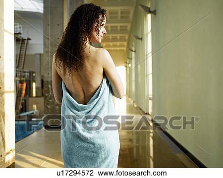 Stock Image - Woman wrapped in towel, rear view. Fotosearch
