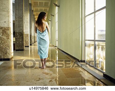 Stock Photograph - Woman wrapped in towel, rear view. Fotosearch