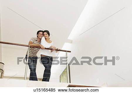 Contented couple lean over balcony View Large Photo Image Stock Photography - Contented couple lean over balcony. Fotosearch