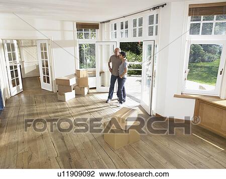 Couple moving boxes into new house. View Large Photo Image Stock Image - Couple moving boxes into new house.. Fotosearch