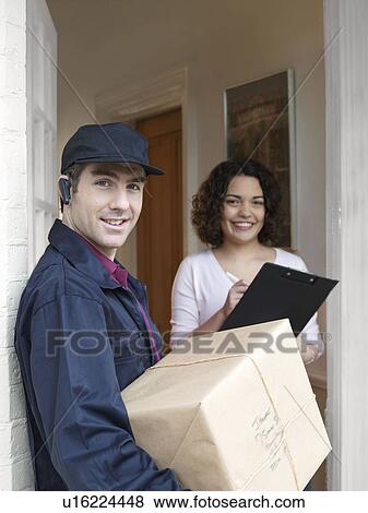 Stock Photo - Courier delivering parcel to woman. Fotosearch