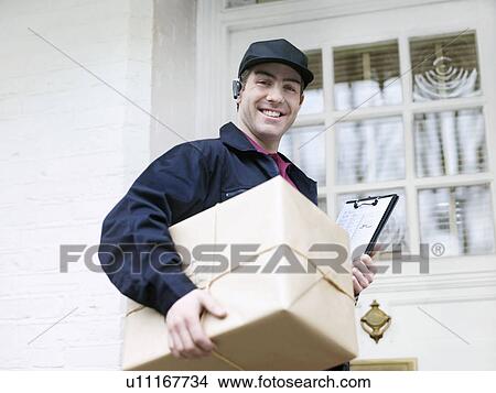 Picture - Courier with large parcel at front door. Fotosearch