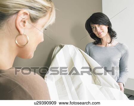 Female Interior Designer Showing Samples Of Striped Fabric