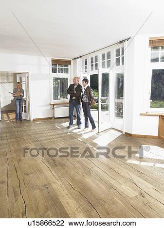 Real estate agent showing empty house to clients. View Large Photo Image Stock Image - Real estate agent showing empty house to clients.. Fotosearch
