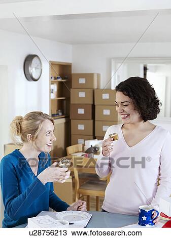 Two women break from work at home View Large Photo Image Stock Image - Two women break from work at home. Fotosearch