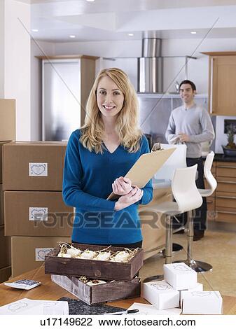 Woman and man in kitchen with boxes View Large Photo Image Stock Image - Woman and man in kitchen with boxes. Fotosearch