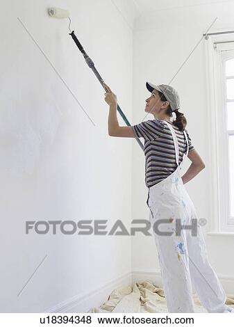 Stock Photo - Woman decorating room. Fotosearch