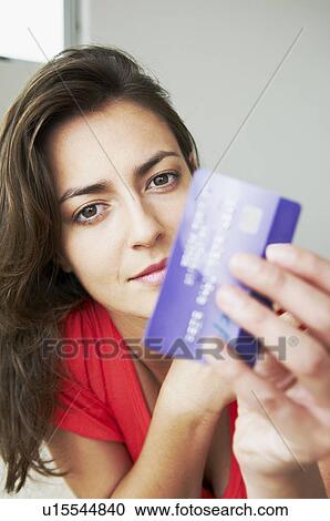 Woman holds credit card to camera View Large Photo Image Stock Image - Woman holds credit card to camera. Fotosearch