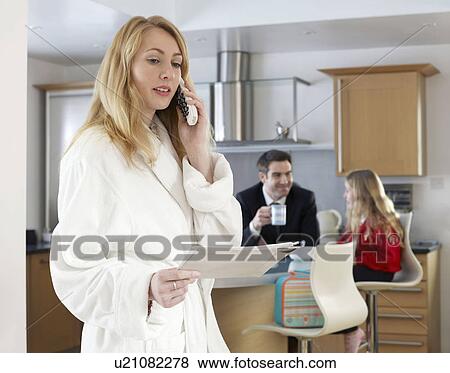 Woman in dressing gown reads post View Large Photo Image Stock Photo - Woman in dressing gown reads post. Fotosearch