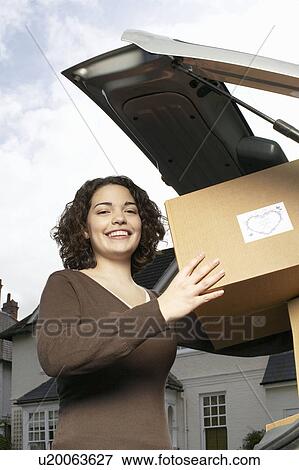 Stock Photo - Woman loading boxes. Fotosearch