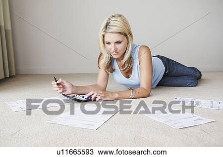 Stock Image - Woman works on home finances. Fotosearch