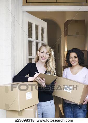 Women with boxes of goods in doorway View Large Photo Image Stock Photo - Women with boxes of goods in doorway. Fotosearch