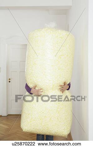 Young woman carrying large bag of packing foam View Large Photo Image Stock Image - Young woman carrying large bag of packing foam. Fotosearch