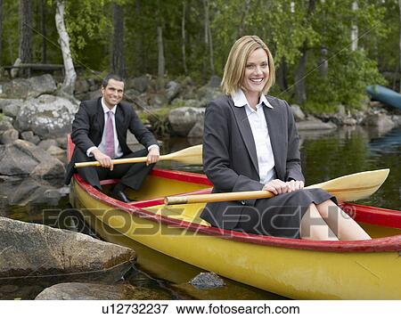 Business couple in a kayak View Large Photo Image Stock Photo - Business couple in a kayak. Fotosearch