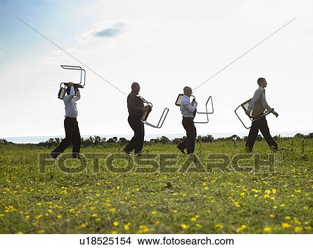 Businessmen walking through field with chairs. View Large Photo Image Picture - Businessmen walking through field with chairs.. Fotosearch
