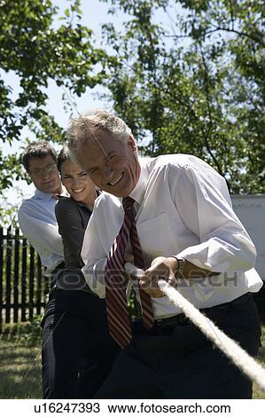 Businesspeople playing tug of war. View Large Photo Image Stock Image - Businesspeople playing tug of war.. Fotosearch