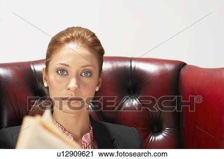 Stock Image - Businesswoman in a comfy leather chair. Fotosearch
