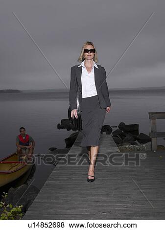 Stock Photo - Businesswoman on a dock. Fotosearch