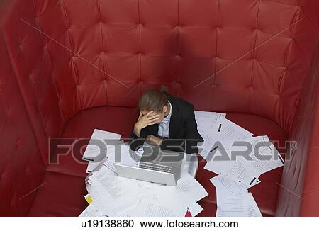 Businesswoman working at a table with red seating View Large Photo Image Stock Image - Businesswoman working at a table with red seating. Fotosearch