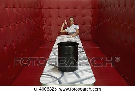 Businesswoman working at a table with red seating View Large Photo Image Stock Photography - Businesswoman working at a table with red seating. Fotosearch