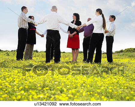 Group of businesspeople in a field. View Large Photo Image Stock Image - Group of businesspeople in a field.. Fotosearch