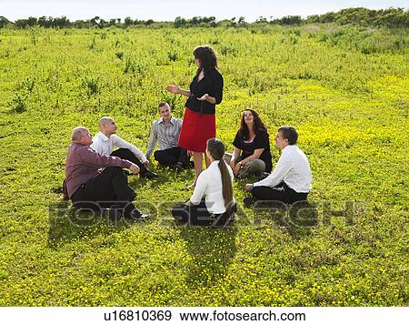 Stock Photo - Group of businesspeople in a field.. Fotosearch