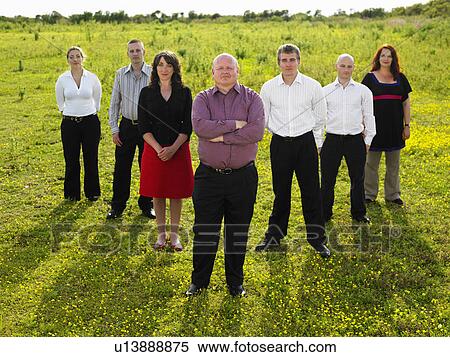 Stock Photography - Group of businesspeople in a field.. Fotosearch