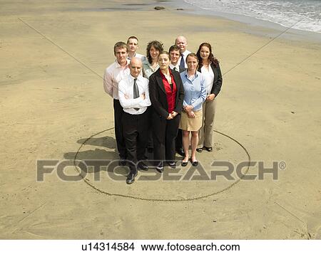 Picture - Group of businesspeople on the beach.. Fotosearch