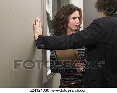 Stock Image - Businessman flirting with businesswoman. Brussels, Belgium.. Fotosearch