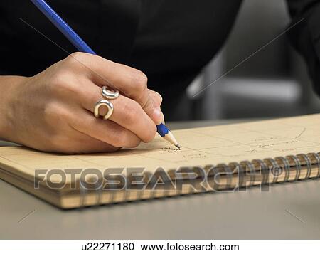 Close-up of businesswoman's hand holding pencil. Brussels, Belgium. View Large Photo Image Stock Image - Close-up of businesswoman's hand holding pencil. Brussels, Belgium.. Fotosearch