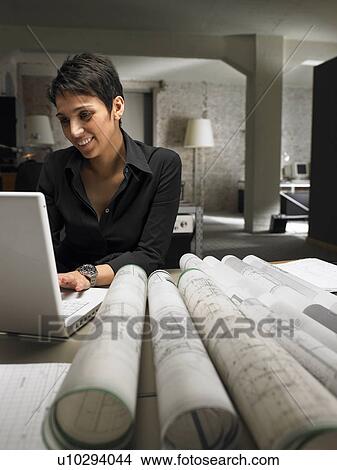 Female architect working on laptop. Brussels, Belgium. View Large Photo Image Picture - Female architect working on laptop. Brussels, Belgium.. Fotosearch