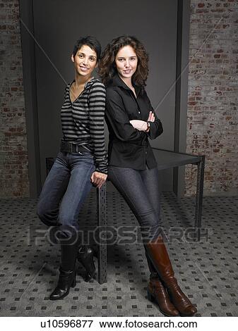 Portrait of two women leaning on table. Brussels, Belgium. View Large Photo Image Stock Photo - Portrait of two women leaning on table. Brussels, Belgium.. Fotosearch