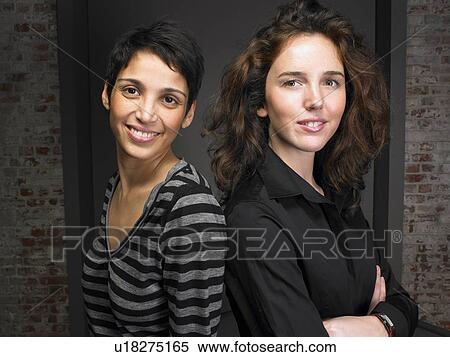 Portrait of two women leaning on table. Brussels, Belgium. View Large Photo Image Stock Photography - Portrait of two women leaning on table. Brussels, Belgium.. Fotosearch