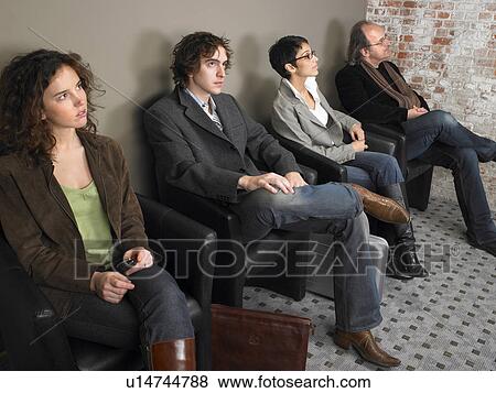 Two businesswomen and two businessmen sitting in waiting room, elevated view. Brussels, Belgium. View Large Photo Image Stock Photo - Two businesswomen and two businessmen sitting in waiting room, elevated view. Brussels, Belgium.. Fotosearch