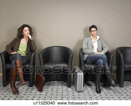 Two businesswomen sitting in waiting room. Brussels, Belgium. View Large Photo Image Stock Image - Two businesswomen sitting in waiting room. Brussels, Belgium.. Fotosearch
