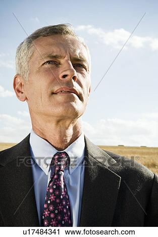 Businessman in a wheat field. View Large Photo Image Stock Image - Businessman in a wheat field.. Fotosearch