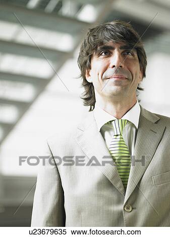 Businessman in an office View Large Photo Image Stock Photography - Businessman in an office. Fotosearch
