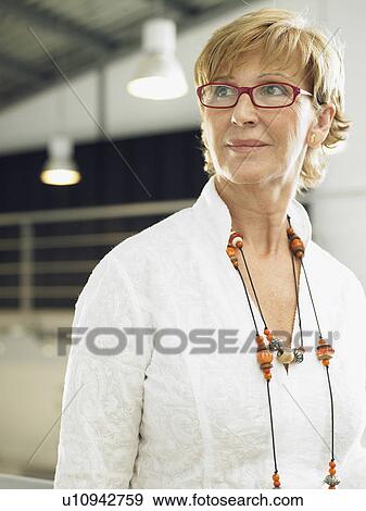 Businesswoman working in an office View Large Photo Image Stock Photo - Businesswoman working in an office. Fotosearch