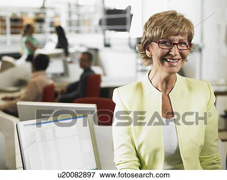 Businesswoman working in an office View Large Photo Image Stock Photo - Businesswoman working in an office. Fotosearch