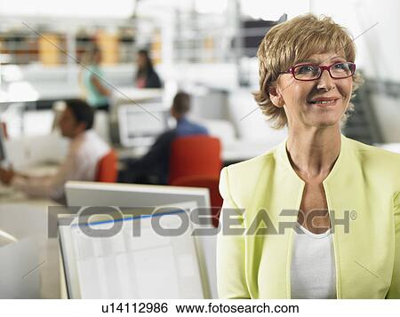 Stock Photograph - Businesswoman working in an office. Fotosearch