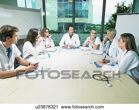 Stock Image - Meeting between a group of doctors.. Fotosearch