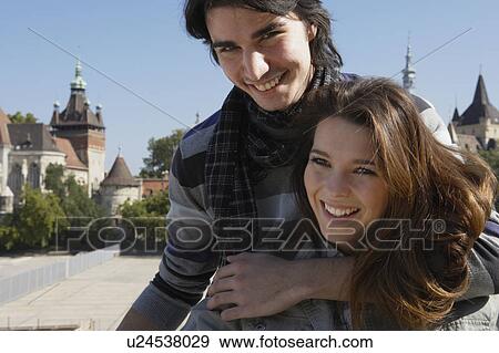 Couple embracing outdoors smiling. View Large Photo Image Stock Photo - Couple embracing outdoors smiling.. Fotosearch