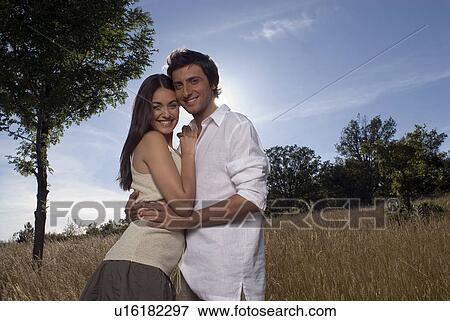 Couple hugging each other View Large Photo Image Stock Photo - Couple hugging each other. Fotosearch
