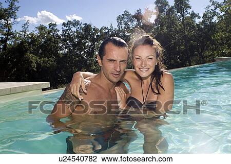 Couple in a swimming pool View Large Photo Image Stock Image - Couple in a swimming pool. Fotosearch