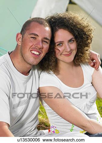 Couple sitting outside tent smiling View Large Photo Image Stock Photograph - Couple sitting outside tent smiling. Fotosearch