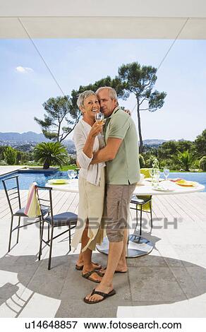 Man and woman embracing by poolside. View Large Photo Image Stock Photo - Man and woman embracing by poolside.. Fotosearch