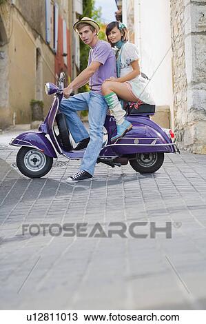 Man and woman on scooter. View Large Photo Image Stock Image - Man and woman on scooter.. Fotosearch