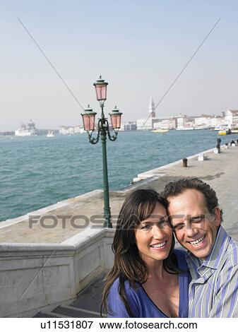 Portrait of couple near lagoon. Venice, Italy. View Large Photo Image Stock Photo - Portrait of couple near lagoon. Venice, Italy.. Fotosearch